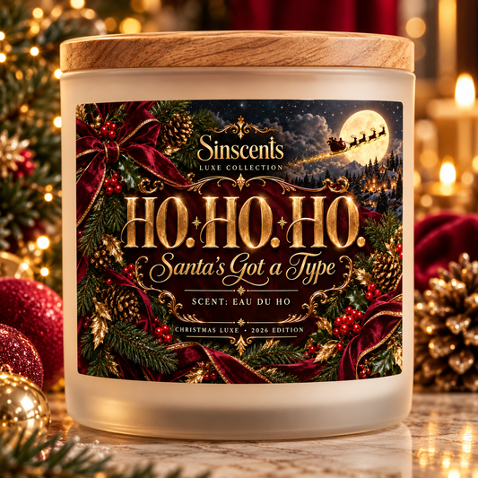 Sinscents HO. HO. HO. candle with a wooden lid and red-and-gold label among Christmas greenery.